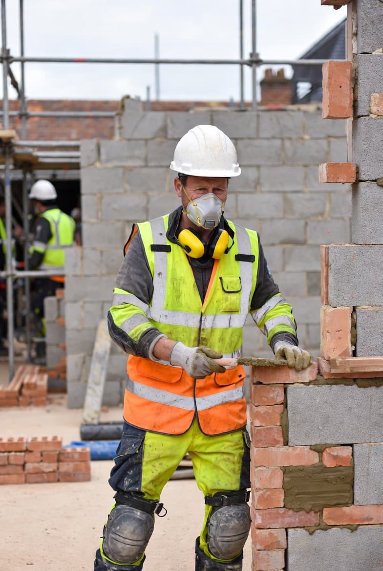 Bricklayer working on construction site